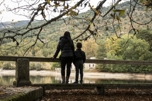 Parent with child looking out at a landscape